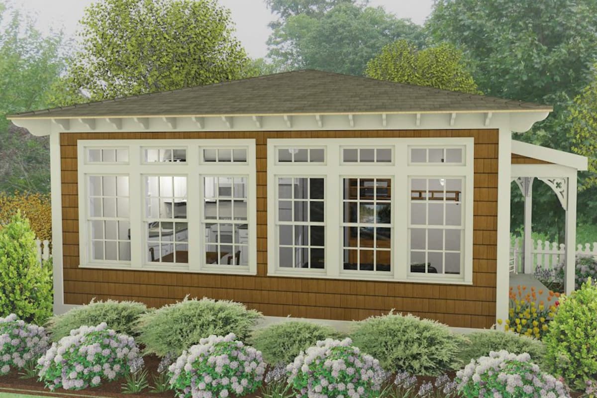 House plan exterior with shingle siding, a hip roof, and a covered porch with decorative brackets. Large multi-pane windows reveal interior.