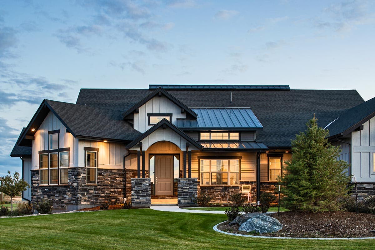 House plan exterior: Modern Farmhouse style, two stories, prominent gables, stone and board-and-batten siding, metal roof.
