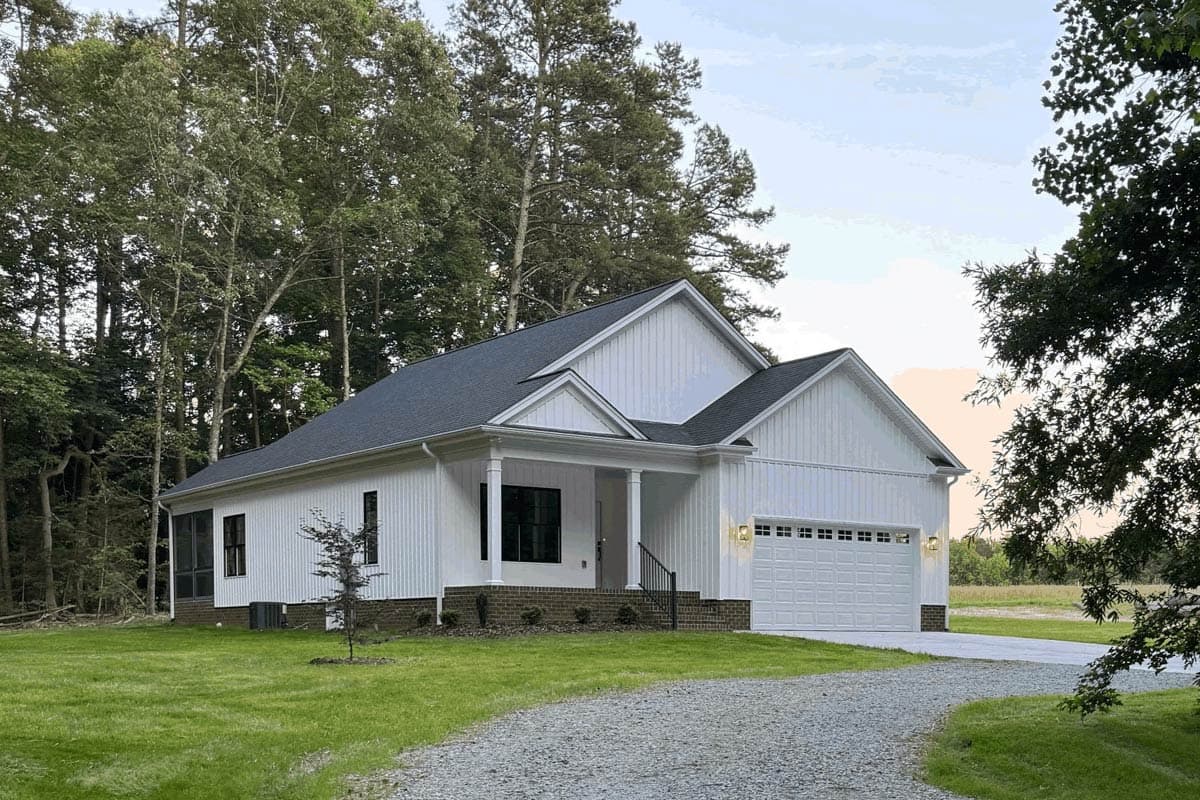 House plan exterior: Modern Farmhouse style, one story, with a covered front porch, board and batten siding, and a two-car side-entry garage.