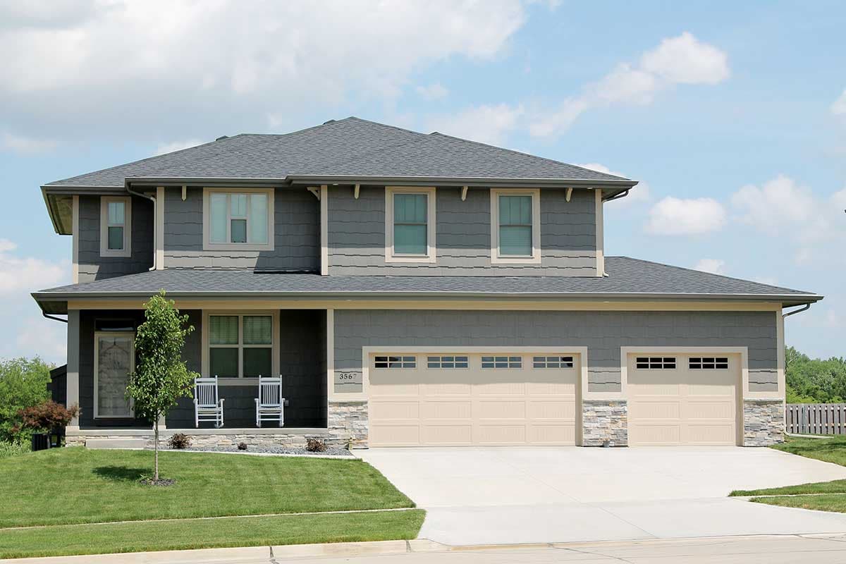House plan exterior: Two-story Modern Farmhouse with a covered front porch, gabled dormers, and a three-car attached garage.