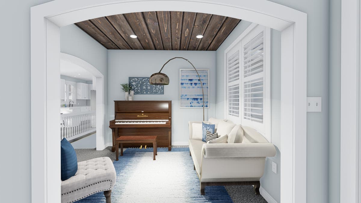 Interior view of a room with a piano, sofa, and wood plank ceiling. Kitchen visible through an archway.