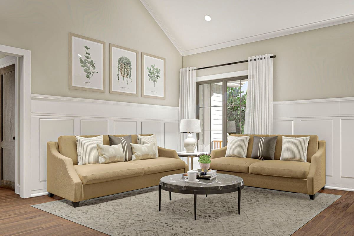 Interior rendering of a living room with vaulted ceiling, two sofas, round coffee table, wainscoting, and framed botanical art.