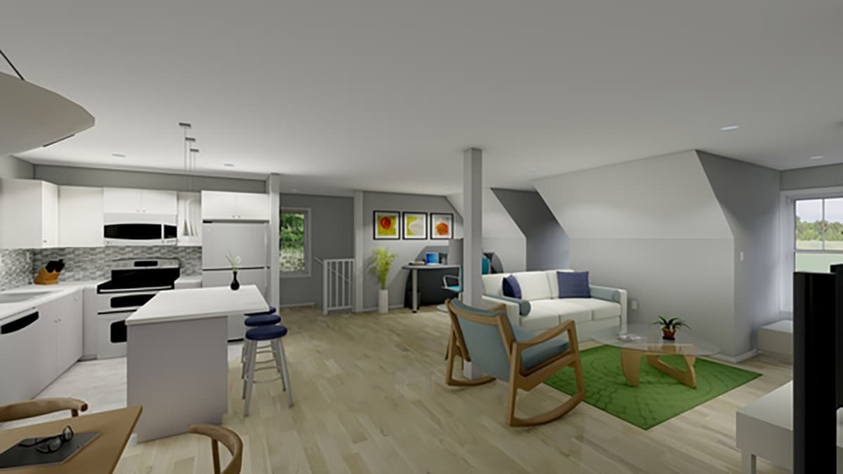 Open concept living space with modern kitchen, island, living area, and desk nook. Sloped ceilings visible.