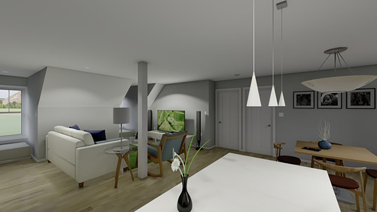 Open concept living, dining, and kitchen area with vaulted ceilings, a sofa, and a dining table with chairs.