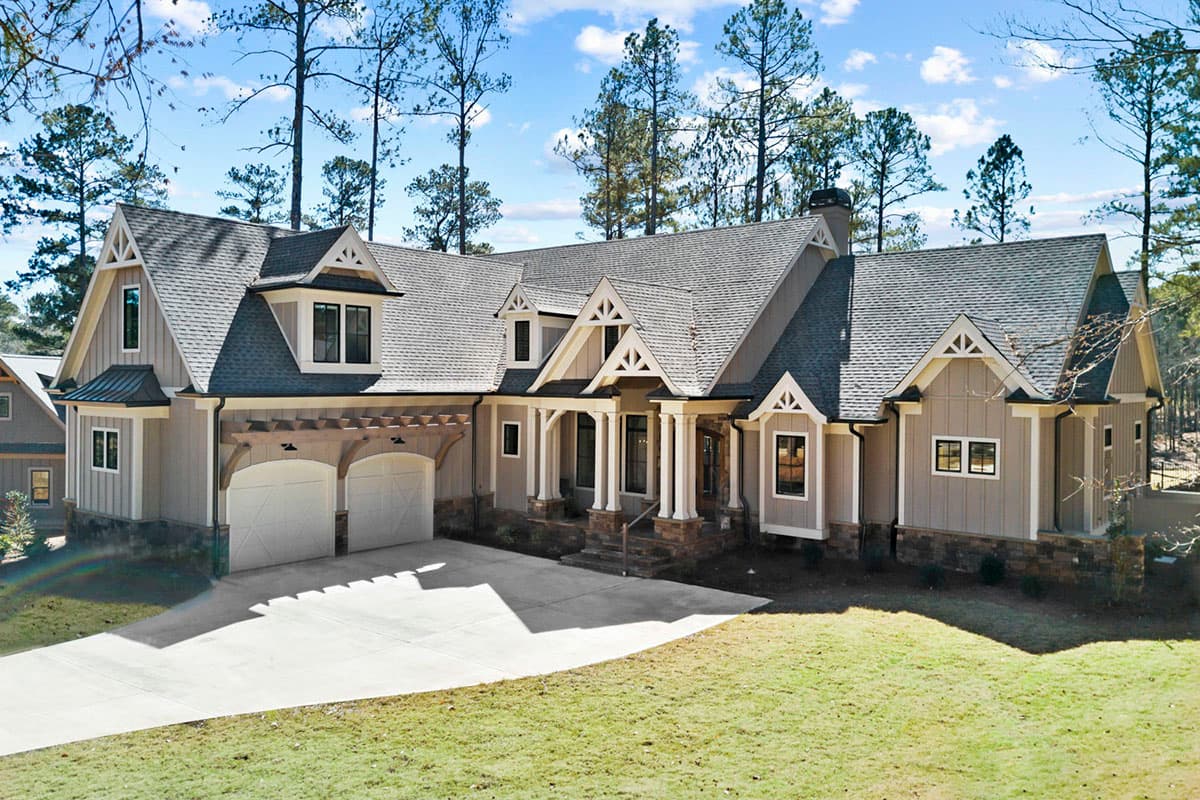 House plan exterior featuring a modern farmhouse style, two-car garage, prominent covered entry with columns, and multiple gables.