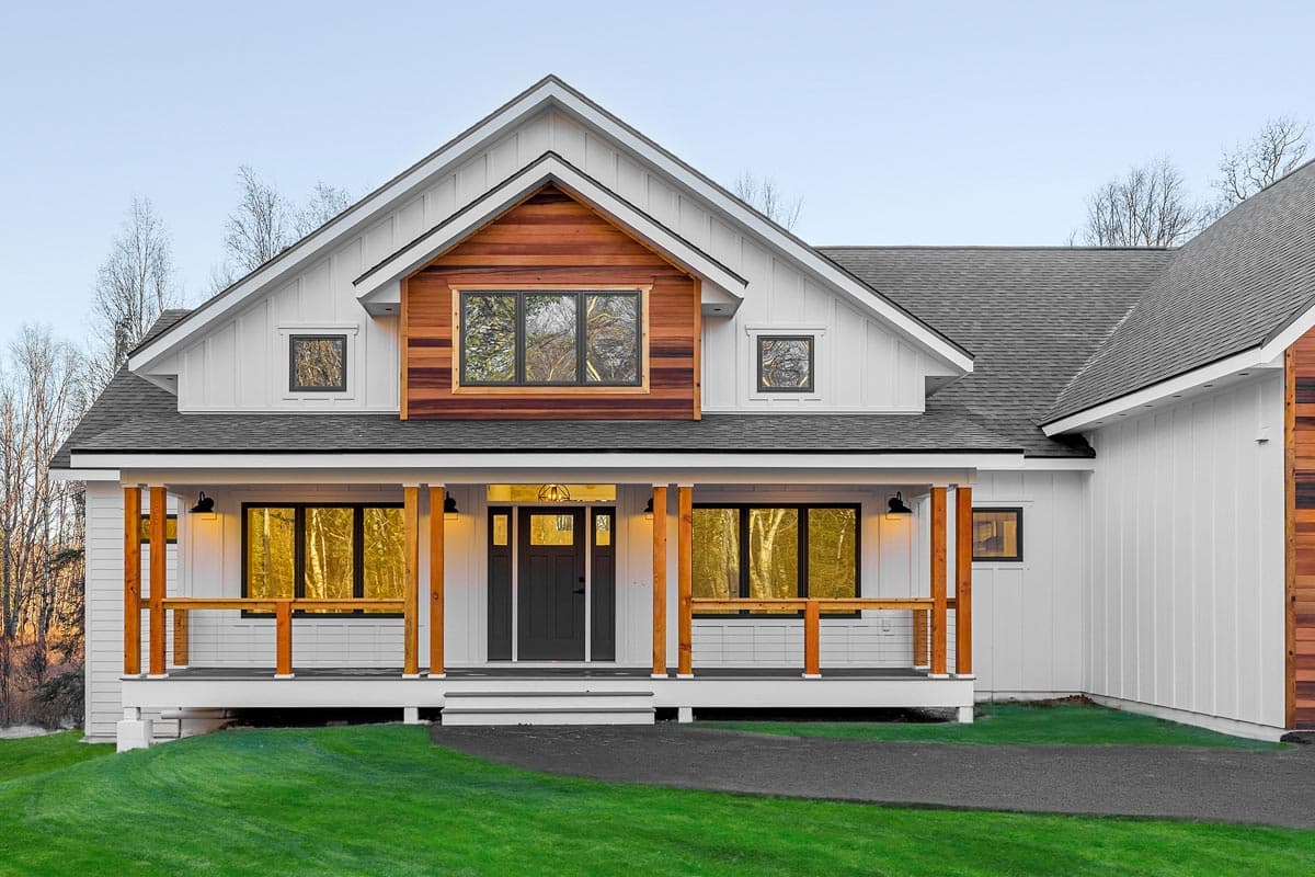 House plan exterior, two-story modern farmhouse with wide covered porch, board and batten siding, and cedar accents.