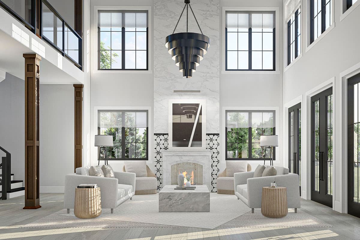 Great room with vaulted ceiling, fireplace, large windows, and second-floor balcony.