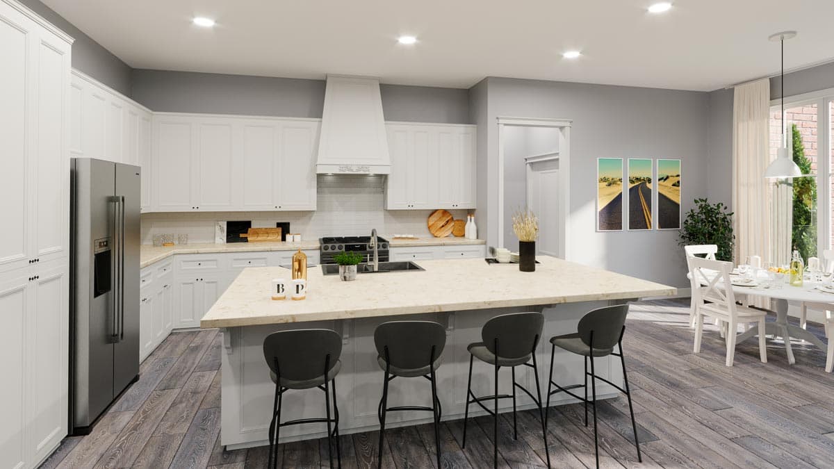 Kitchen with white cabinets, large island with bar stools, stainless steel refrigerator, and adjacent dining area.
