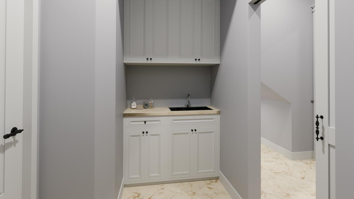 Mudroom with white cabinetry, granite countertop, black sink, and tiled floor.