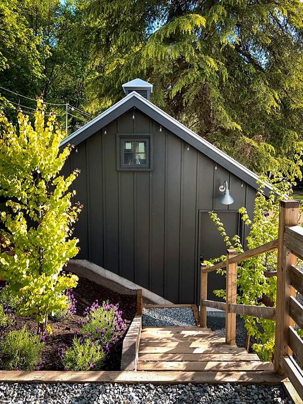 Modern shed exterior with vertical siding, gable roof, and a single window.