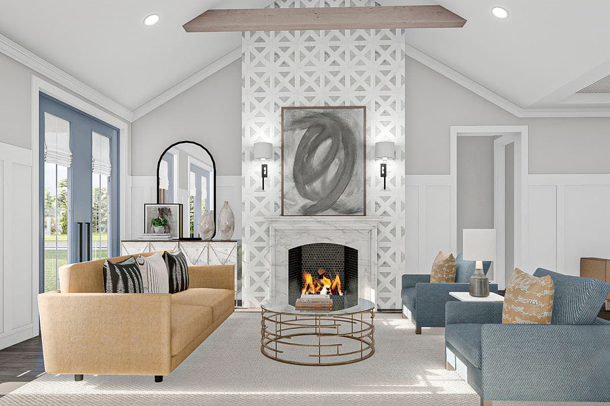 Living room with vaulted ceiling, stone fireplace, and double doors leading outdoors.