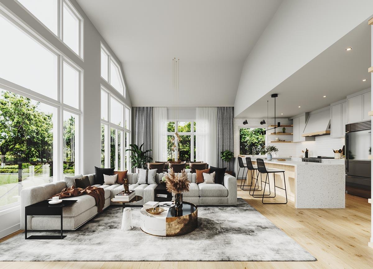 Open-concept living and kitchen area with vaulted ceilings, floor-to-ceiling windows, large sectional, and island.