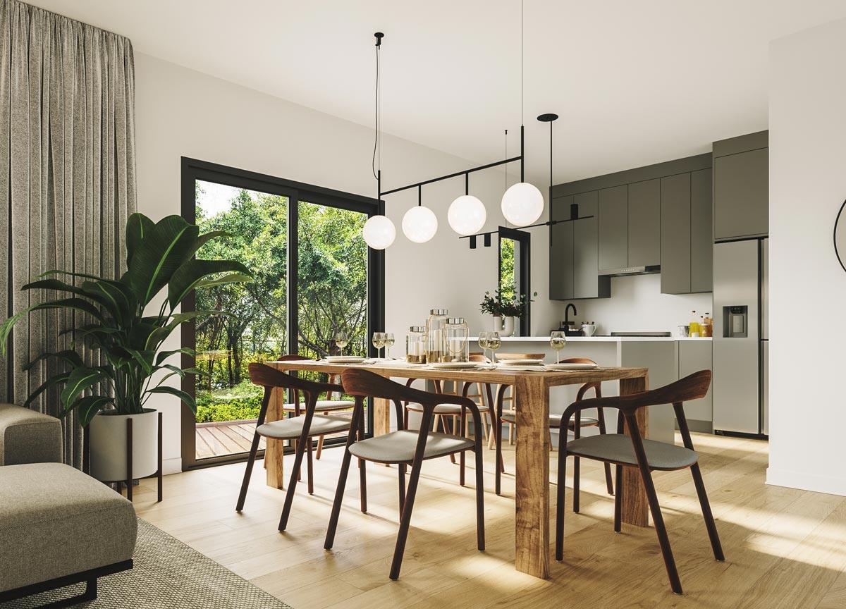 Dining area and open kitchen with large windows overlooking greenery, island, and modern pendant lighting.