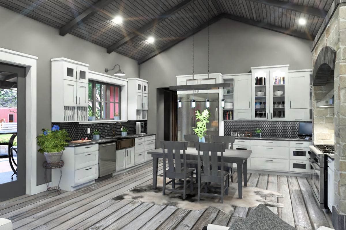 Kitchen with white cabinetry, stainless steel appliances, beamed ceiling, and dining area with gray table and chairs.
