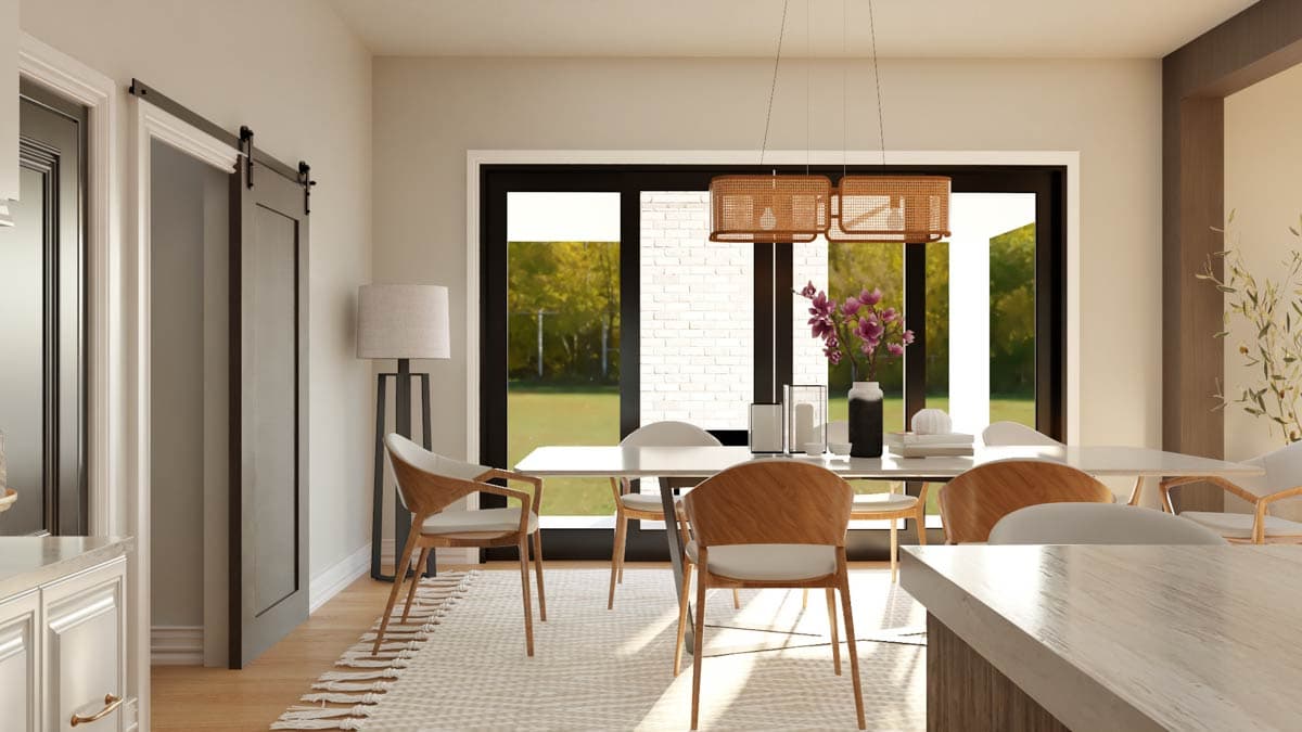 Dining area with a large window, pendant lights, and wood-accented chairs around a table.