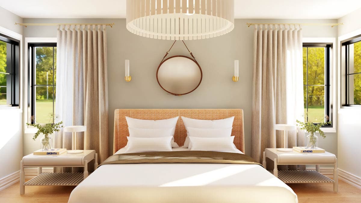 Bedroom with rattan headboard, white bedding, bedside tables, and large windows with beige curtains.