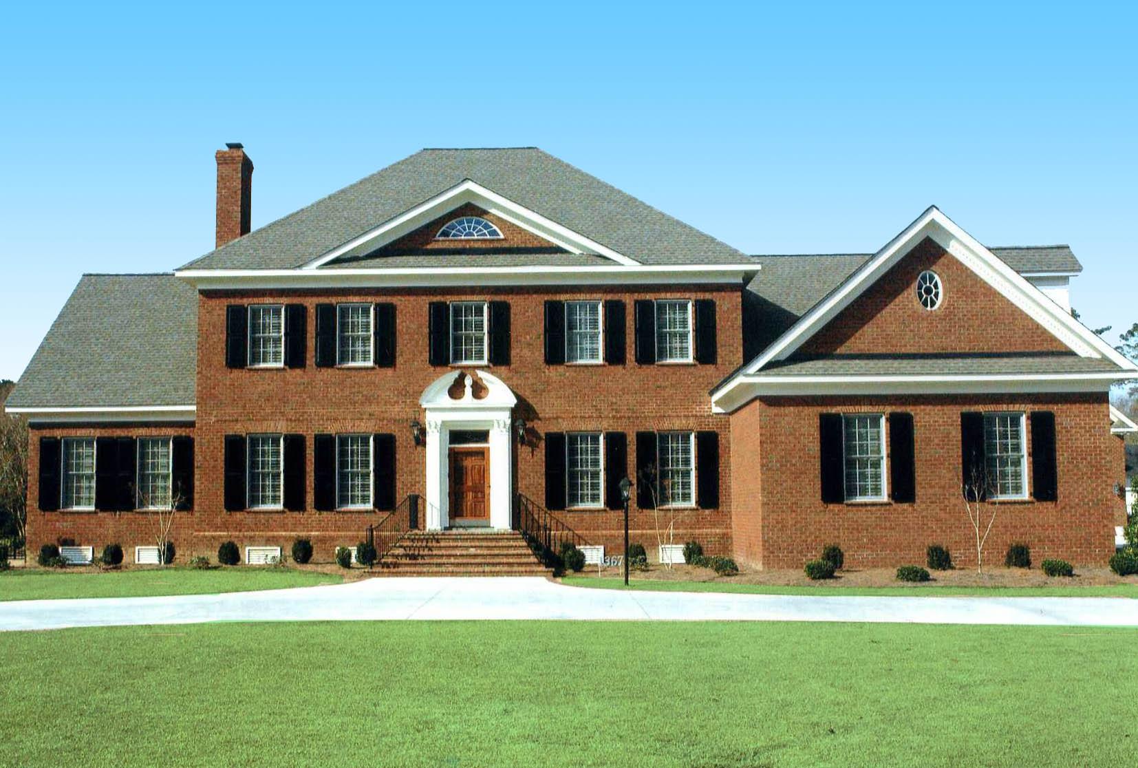House plan exterior: Two-story brick home with a central entrance, symmetrical windows with shutters, and a prominent gable roofline.