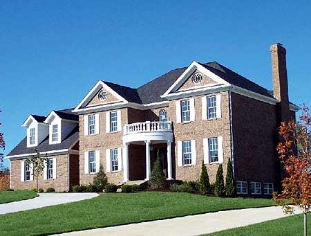 House plan exterior: Two-story brick home with a curved portico, dormer windows, and a prominent brick chimney.