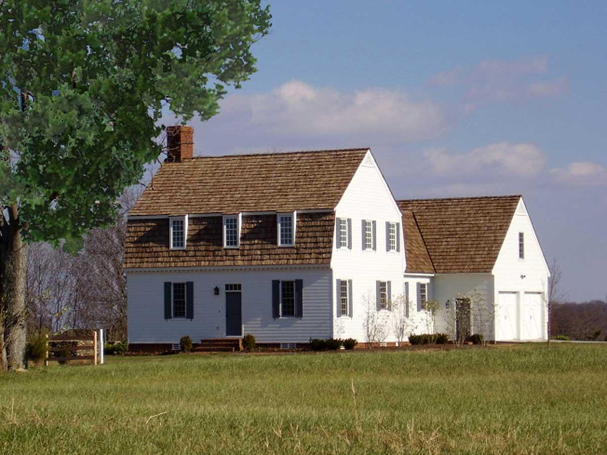 House plan exterior, two-story Colonial style with central entry, dormers, and attached two-car garage.