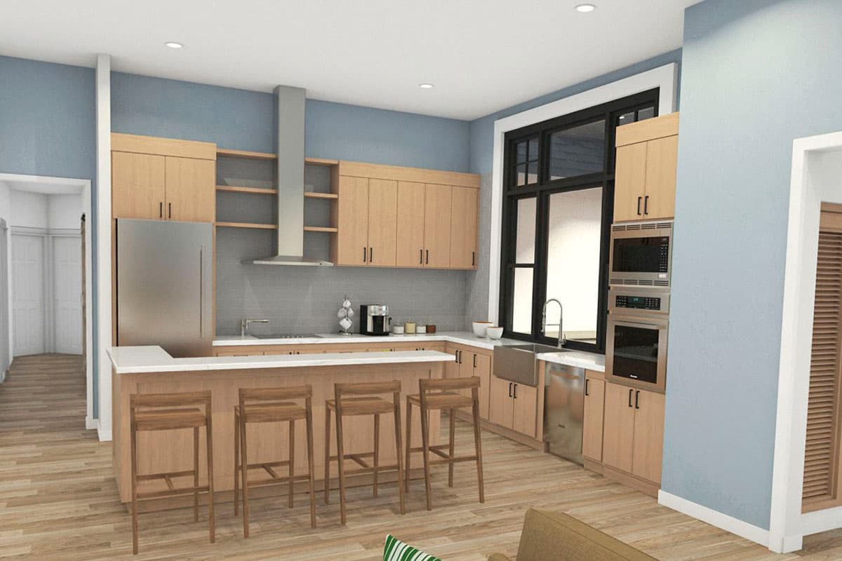 Modern kitchen with light wood cabinets, stainless steel appliances, large island with seating, and expansive window.