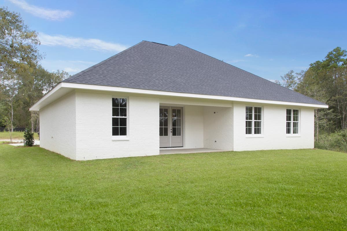 House plan exterior: White brick, one-story, gable roof, french doors, and multiple double-hung windows.