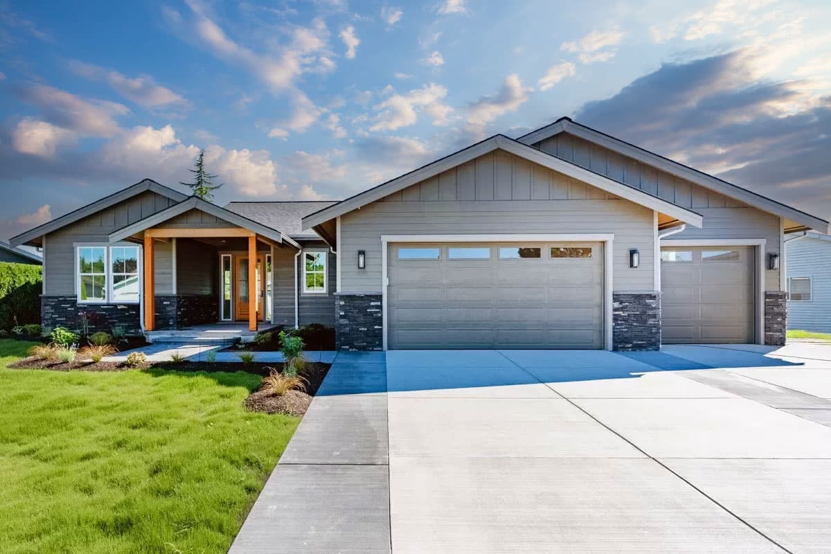 Ranch style house plan exterior with a covered entry with wood posts, siding, stone accents, and a triple-car garage.