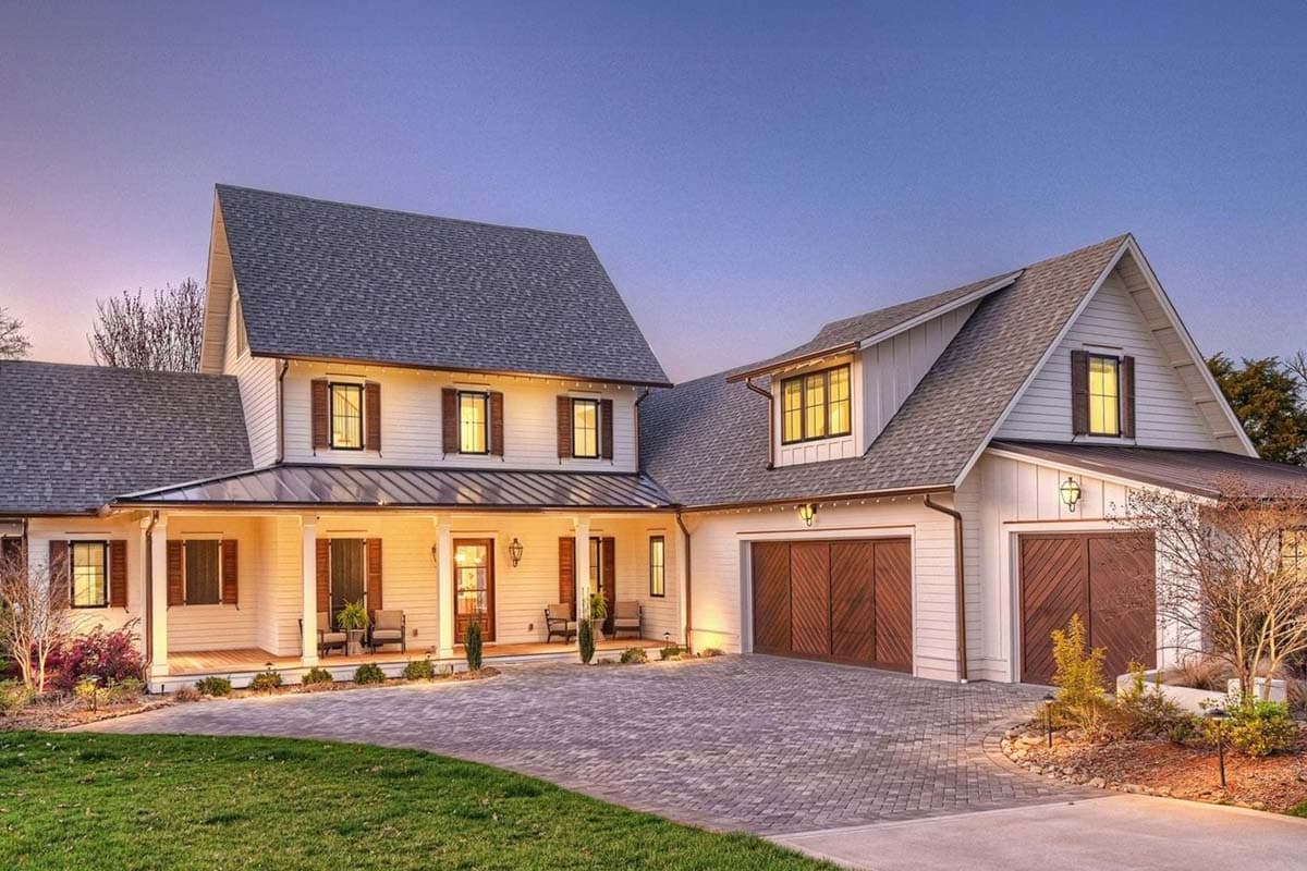 Modern Farmhouse house plan exterior with wraparound porch, gables, dormers, and a three-car garage.
