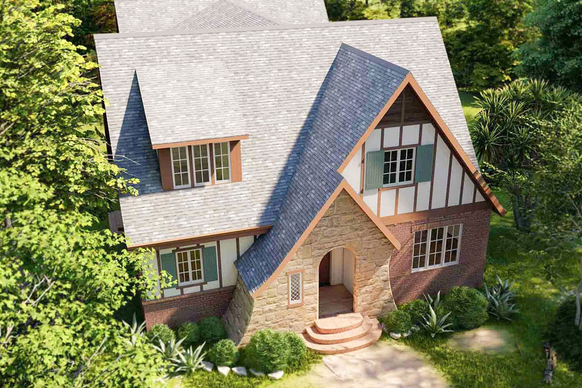 House plan exterior with Tudor style, stone arch entry, half-timbering, dormers, and multi-pane windows.