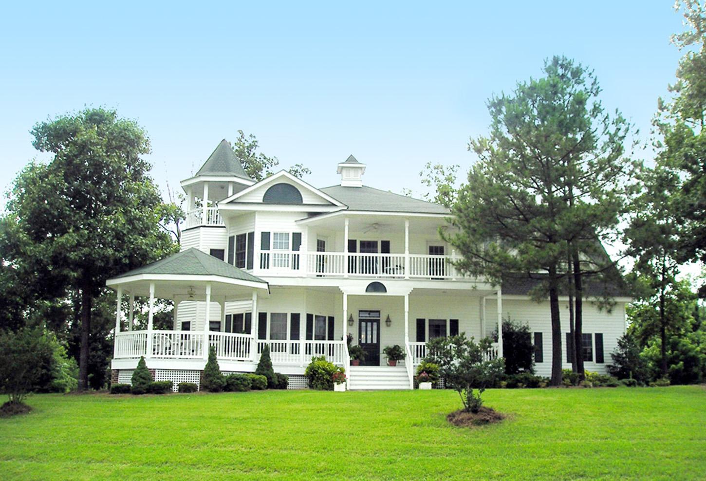 White two-story house plan with wrap-around porch, tower, and gazebo.