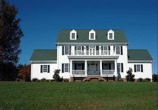 Colonial style house plan exterior with a central portico, dormer windows, and a second-story balcony.