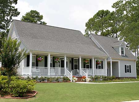 House plan exterior: Two-story home with wrap-around porch, gables, and dormer window.