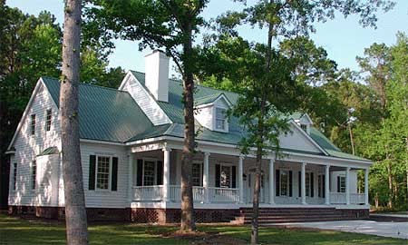 House plan exterior: Two-story, white siding, green metal roof, prominent wrap-around porch with columns and dormers.