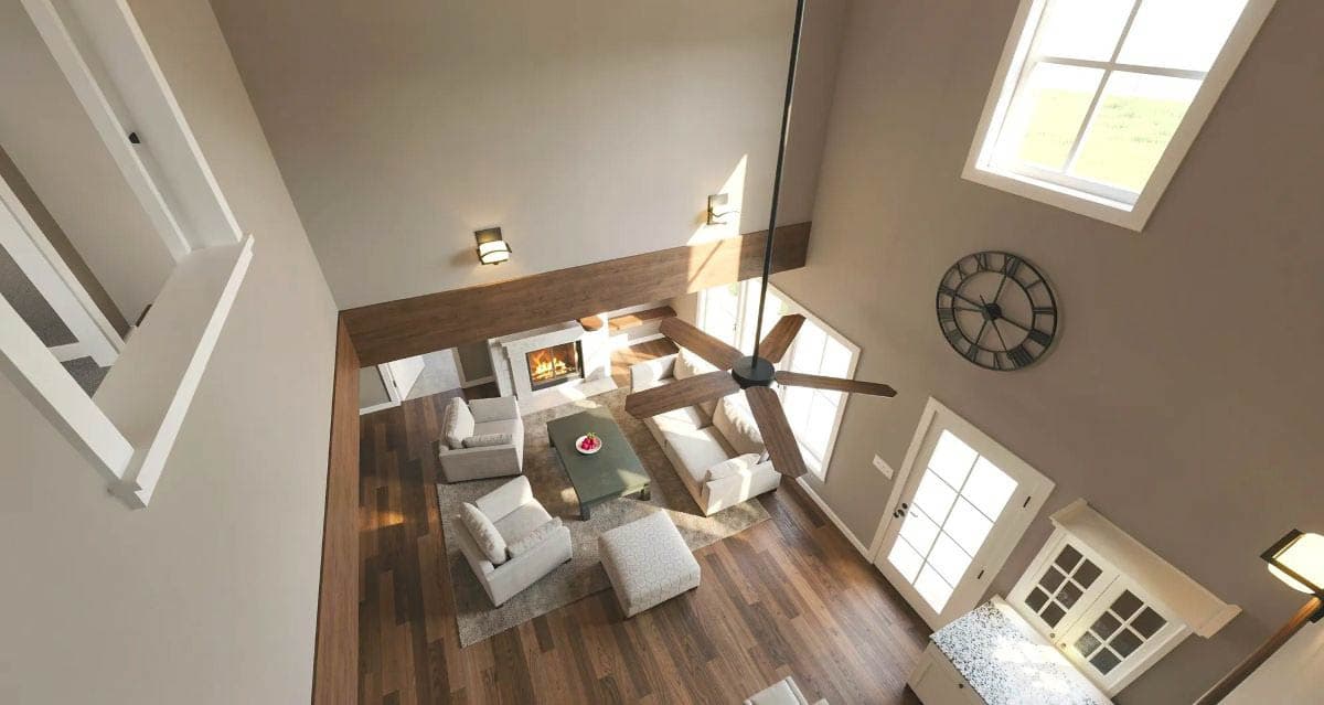 Interior view of open-concept living room with fireplace, vaulted ceiling, exposed wood beam, and large windows.