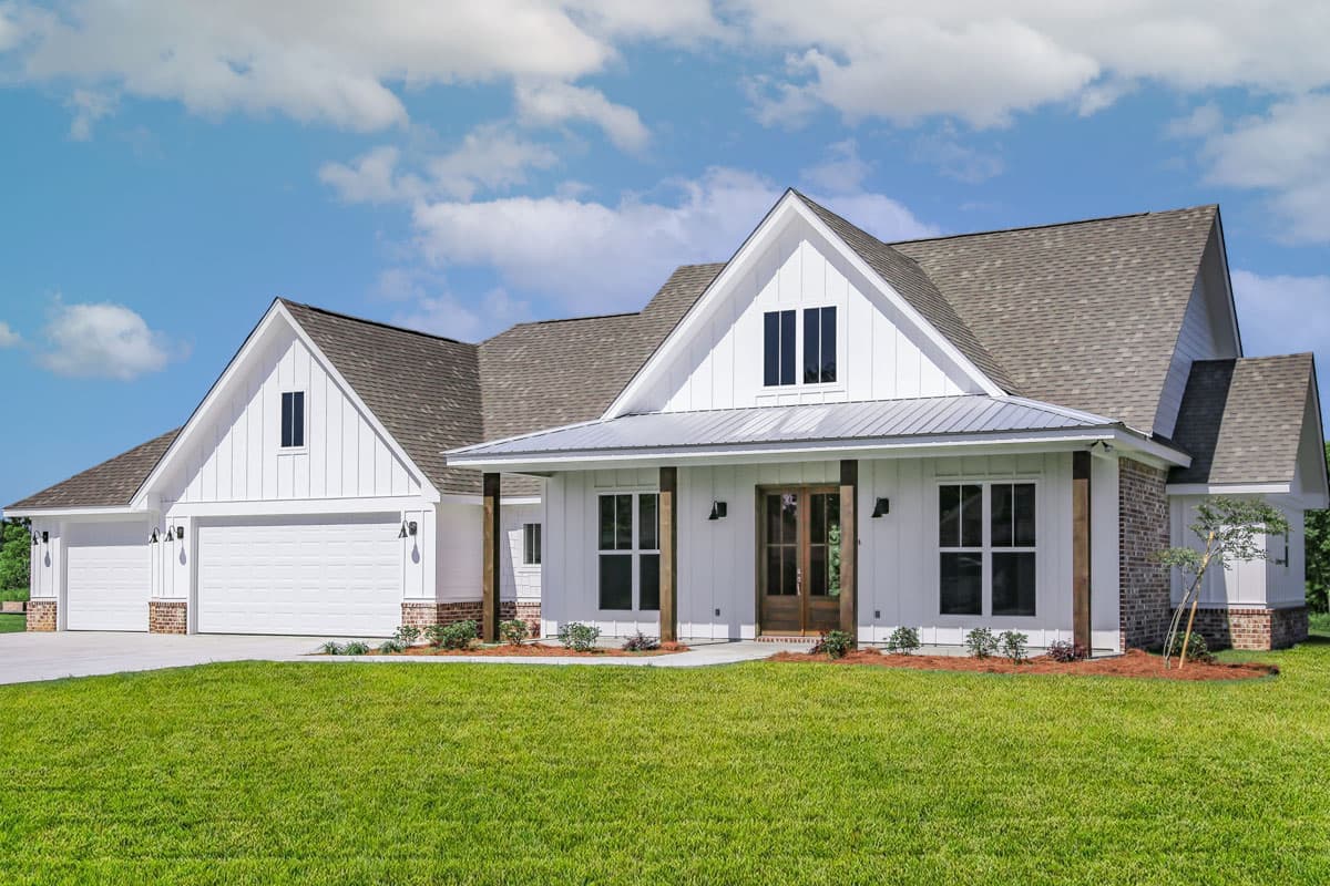 House plan exterior with Modern Farmhouse style. Two-story home with a gabled roof, covered porch, and a two-car garage.