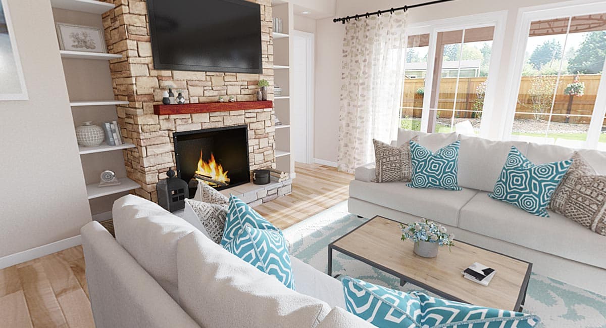 Living room with stone fireplace, built-in shelves, and large windows overlooking a backyard.
