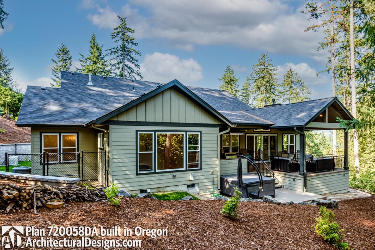 Ranch style house plan exterior with gabled rooflines, covered deck, and hot tub.