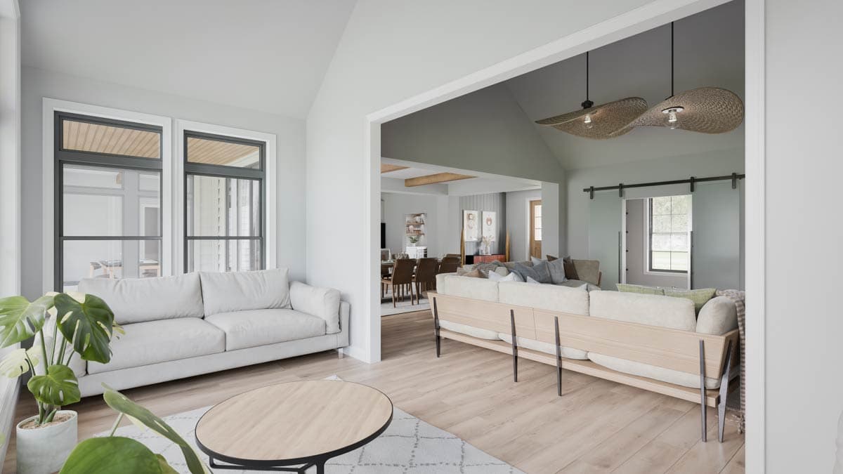 Open-concept living area with vaulted ceiling, farmhouse accents, and modern furniture.