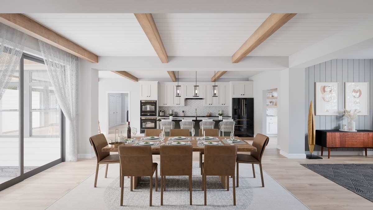 Open concept dining area and kitchen with beamed ceiling, island seating, and modern cabinetry.