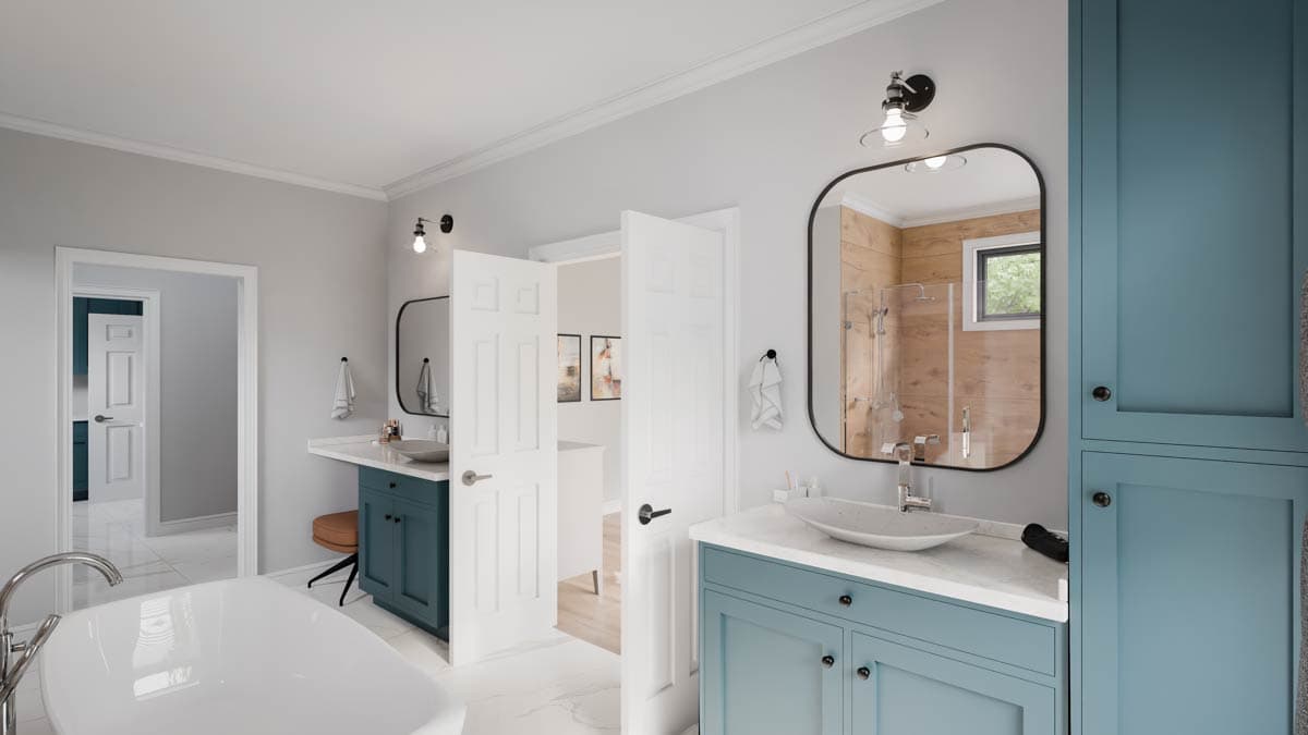 Modern bathroom with double vanity, freestanding tub, walk-in shower, and blue cabinetry.