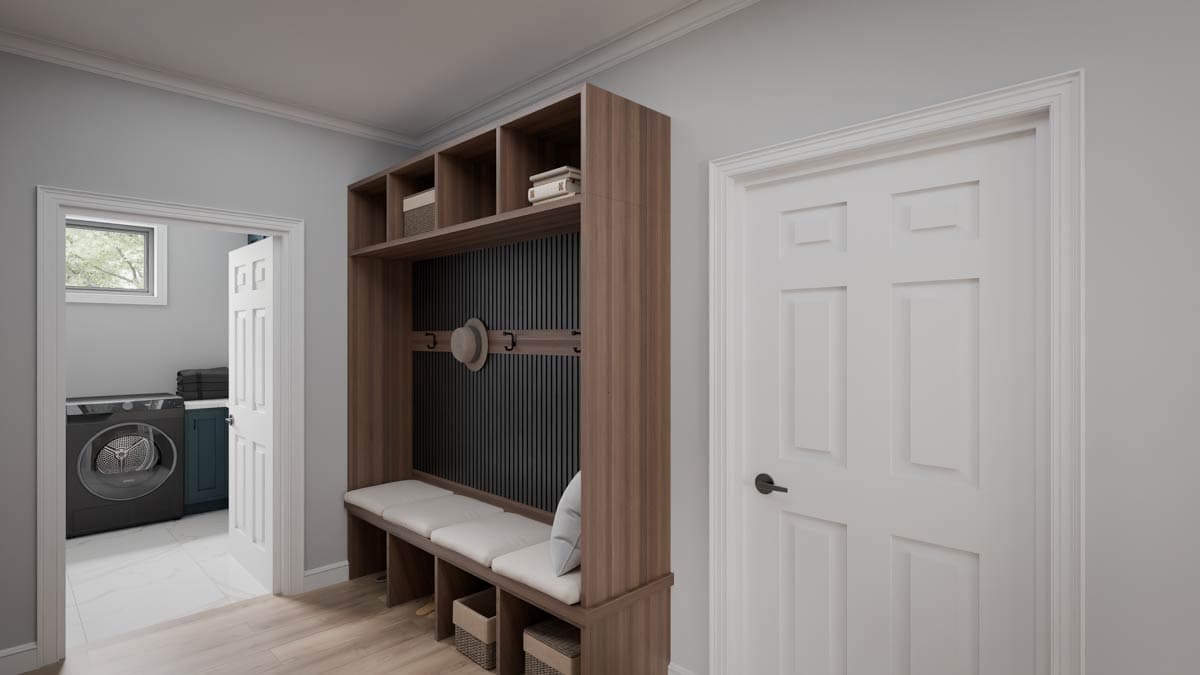 Mudroom with built-in storage bench, open shelving, coat hooks, and doorway to laundry room with washer and dryer.