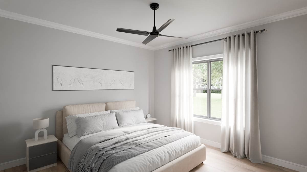 Bedroom interior with bed, nightstand, ceiling fan, and large window with white curtains.