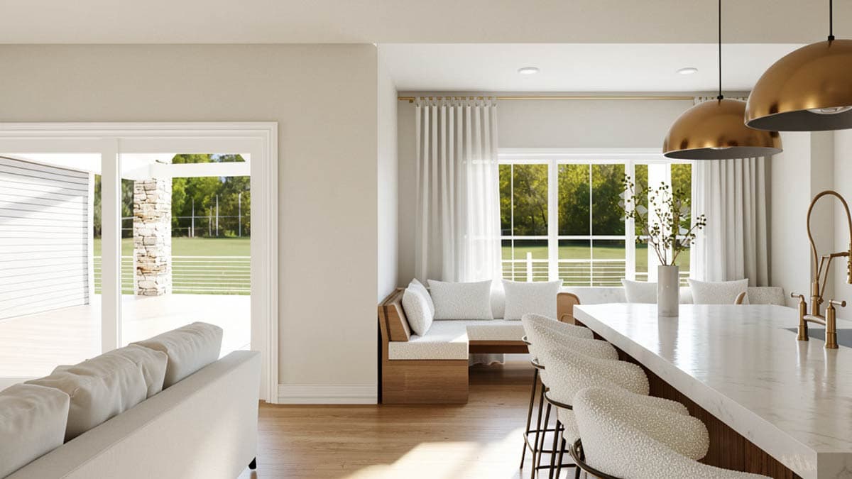 Modern house interior: open-concept kitchen with island seating, banquette, and large windows overlooking outdoor patio.