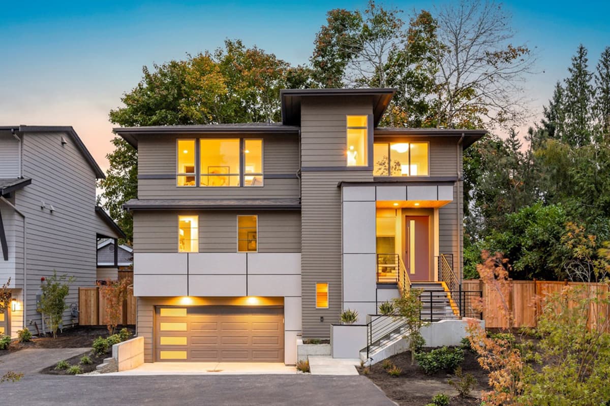 House plan exterior. Two-story Modern house with flat roof, horizontal siding, large windows, and an attached garage.