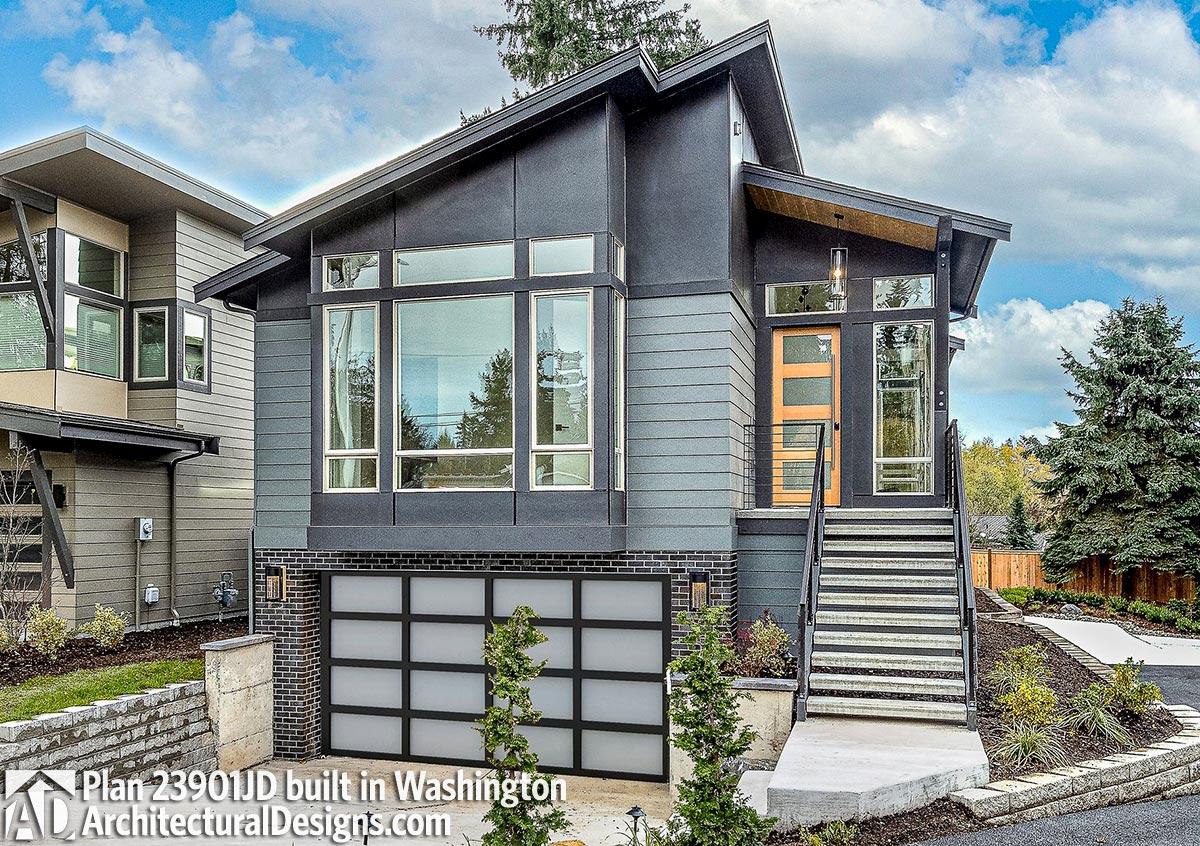 House plan exterior with modern design. Features include a clerestory window, shed roof, and glass garage door.