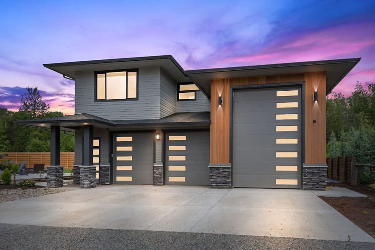 Modern two-story house plan exterior with three-car garage, large windows, covered porch, and wood and stone accents.