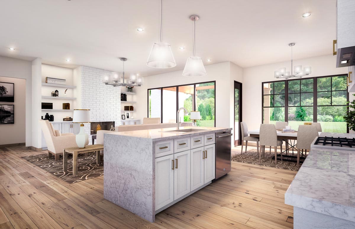 Open concept living space with kitchen island, fireplace, dining area, and large windows.