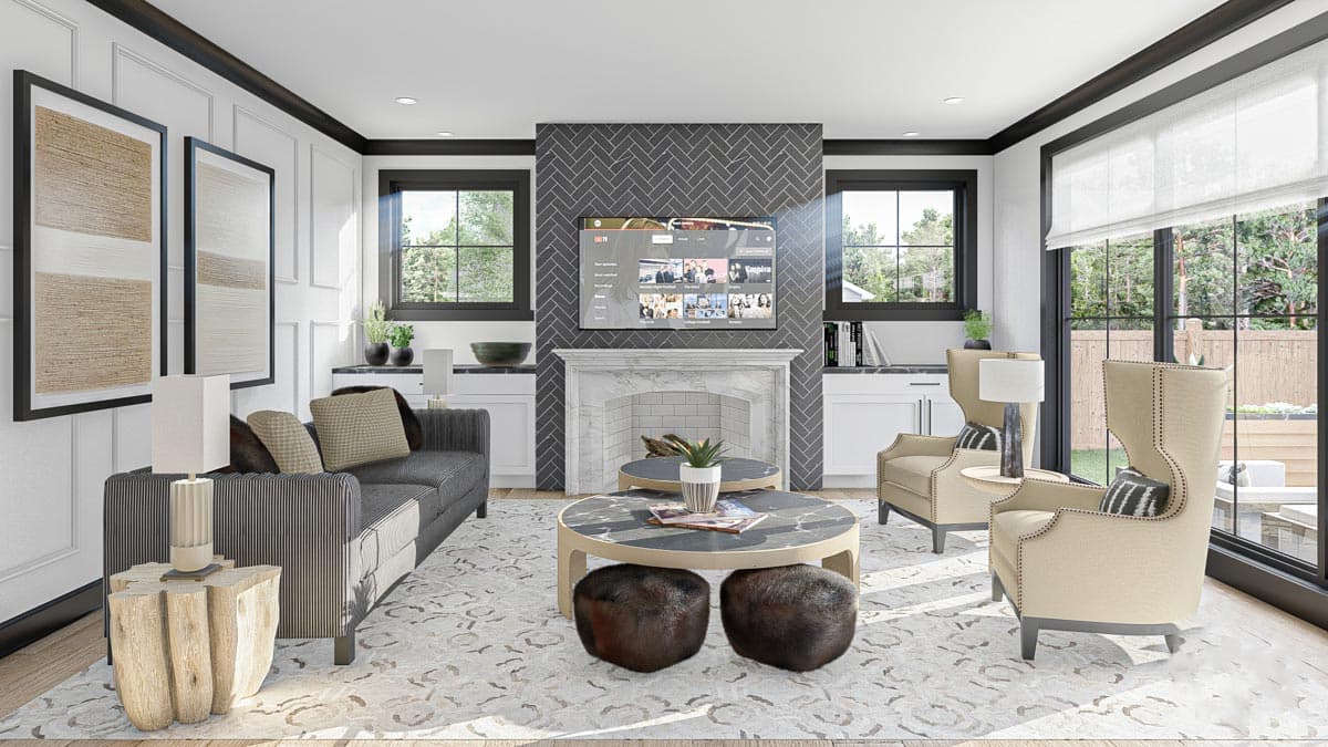 Living room with marble fireplace, herringbone tile surround, mounted TV, and two cream wingback chairs.