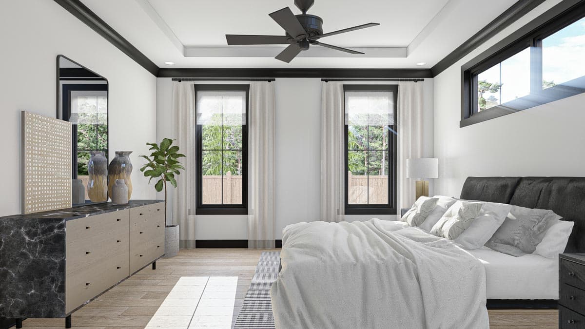 Interior rendering of a bedroom with a king-size bed, dresser, black framed windows, and a ceiling fan.