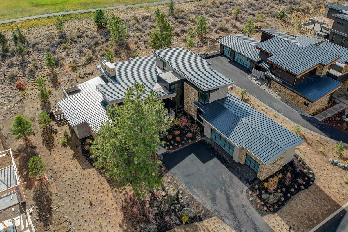 Modern house plan exterior with multiple gables, stone accents, and attached garages.