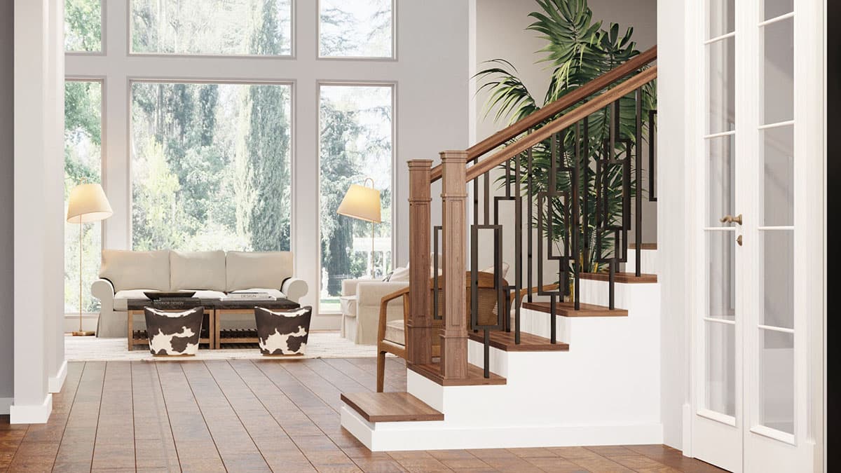 Interior view: staircase with wood treads and risers, modern metal balusters, and tall windows in the adjacent living area.